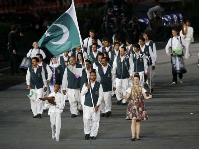 Pakistan's flag bearer Sohail Abbas holds the national flag as he leads the contingent in the athletes parade during the opening ceremony of the London 2012 Olympic Games at the Olympic Stadium July 27, 2012. PHOTO: REUTERS