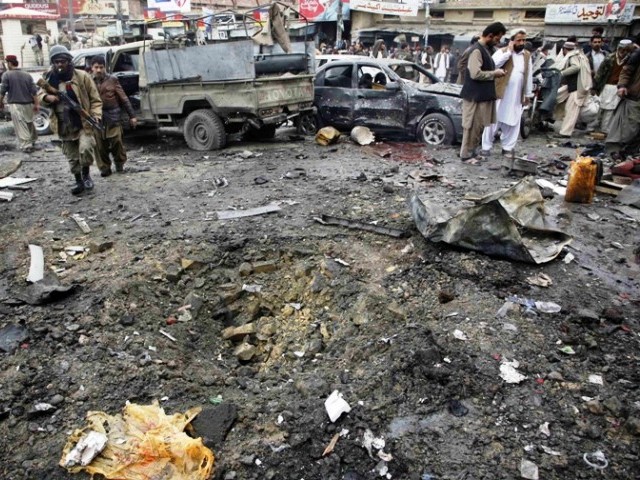 Pakistani security officials examine the site of a bomb attack in Quetta on January 10, 2013. PHOTO: AGENCIES