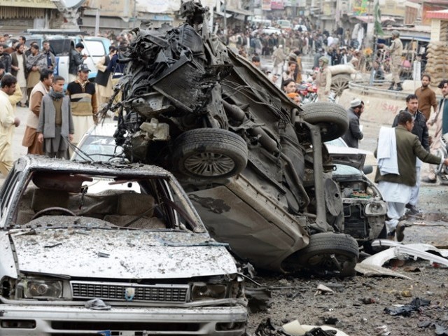 Pakistani security officials examine the site of a bomb attack in Quetta on January 10, 2013. PHOTO: AGENCIES